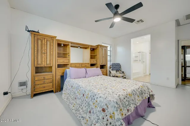 a bedroom with a bed chair and a window