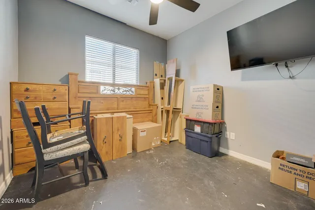 a view of swimming pool with lawn chairs and plants