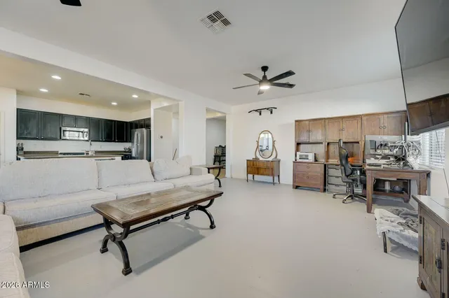 a living room with furniture and kitchen view