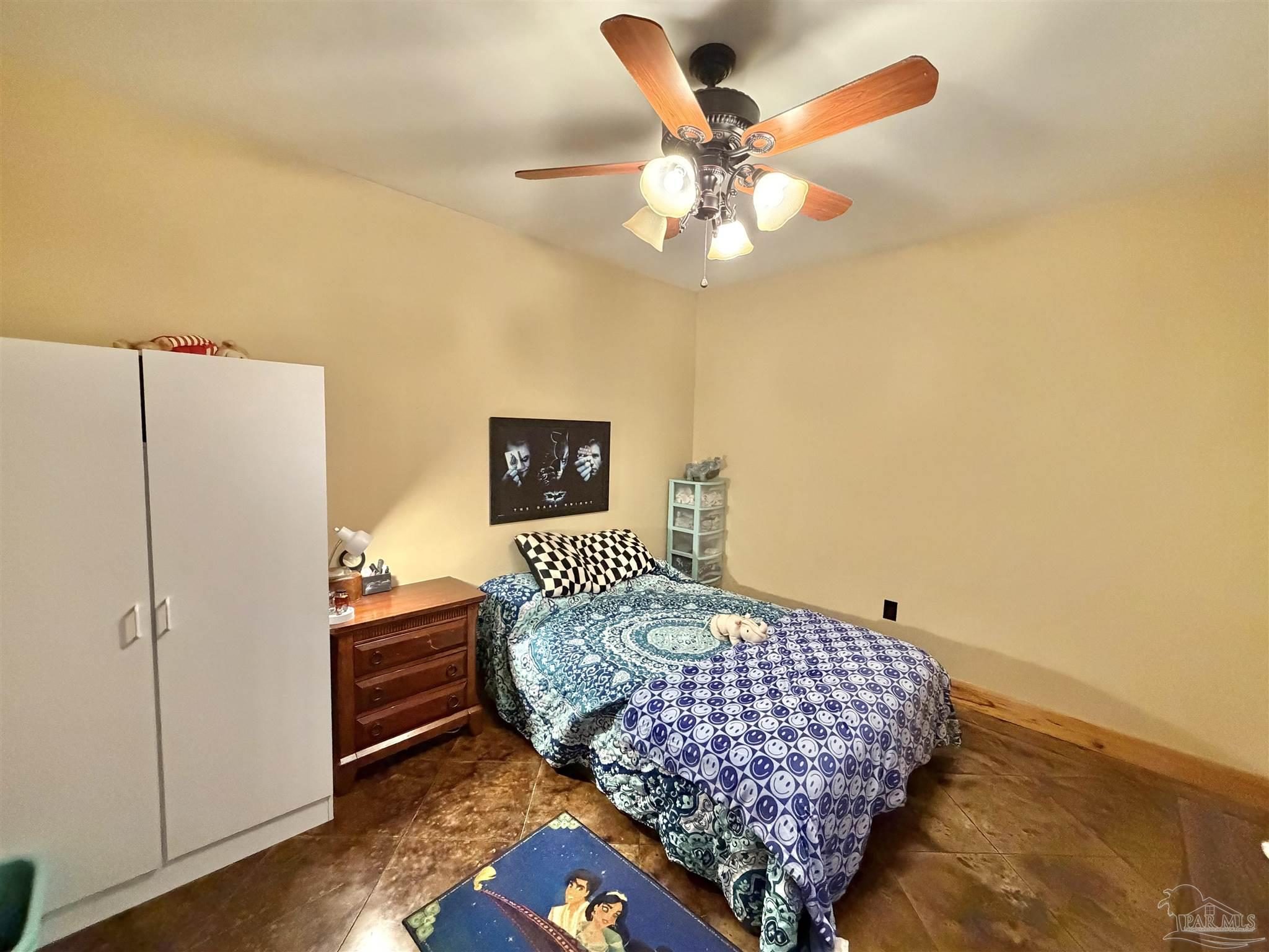 145 Tower Road Uriah, AL 36480 - Photo 20 of 72 a bedroom with a bed and a chandelier