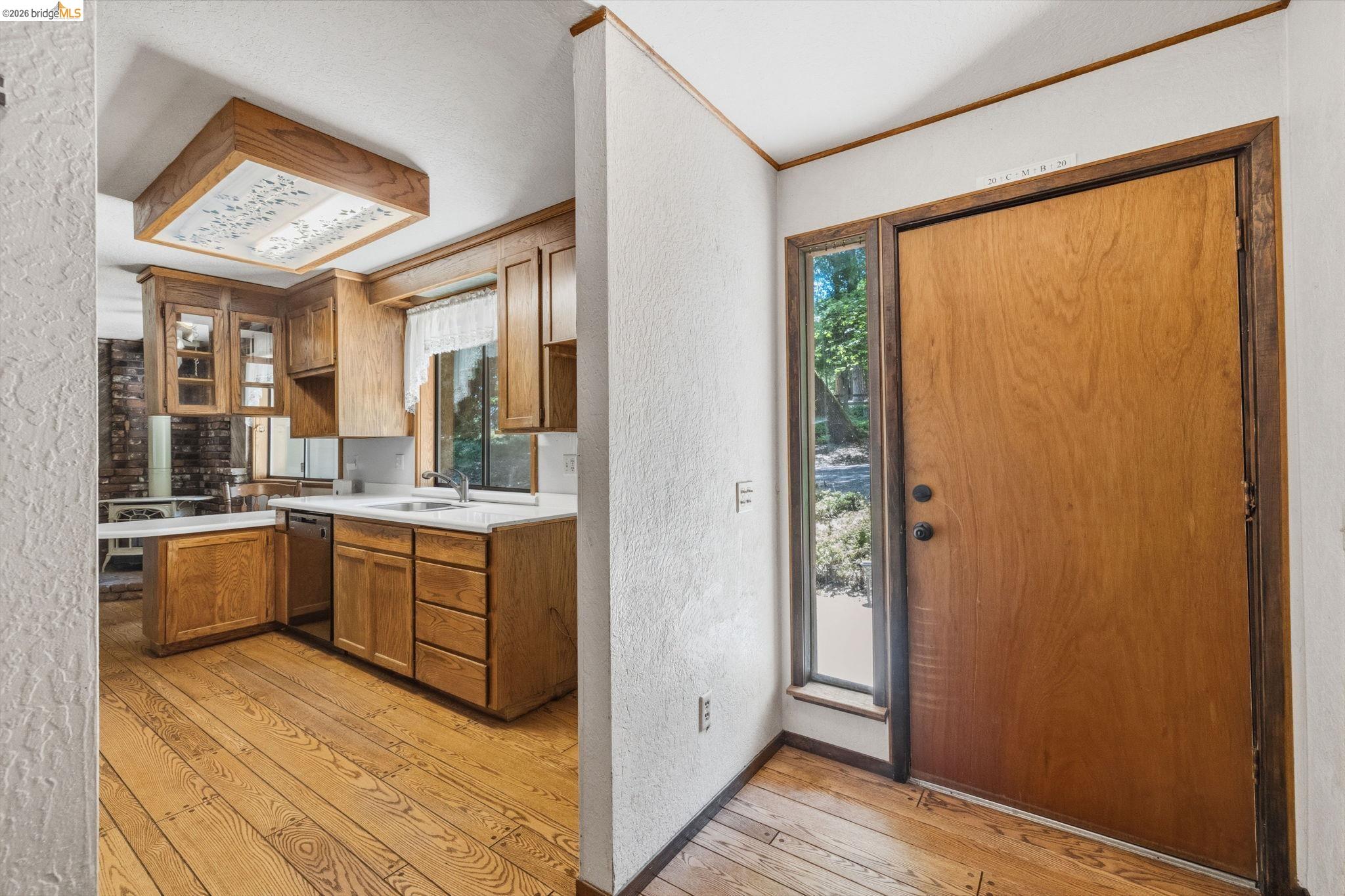 22401 South Fork Road Sonora, CA 95370 - Photo 12 of 34 Wood-finish flooring extending from the entryway into the kitchen