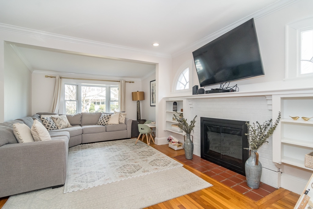 12 Durant Road Wellesley, MA 02482 - Photo 3 of 18 a living room with furniture a flat screen tv and a fireplace