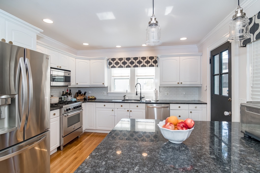 12 Durant Road Wellesley, MA 02482 - Photo 4 of 18 a kitchen with a stove a sink and a refrigerator