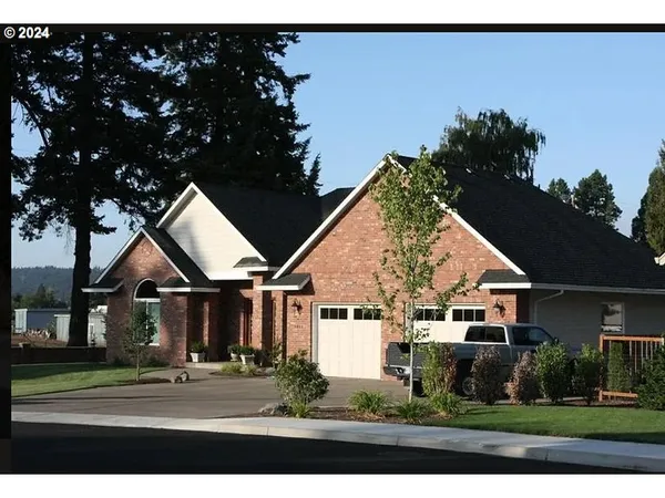 a front view of a house with a yard and street view