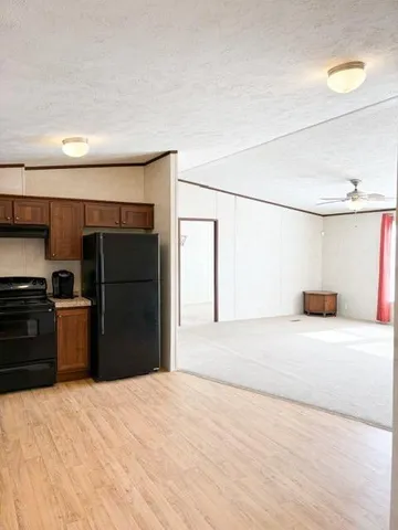 a kitchen with a refrigerator and a stove