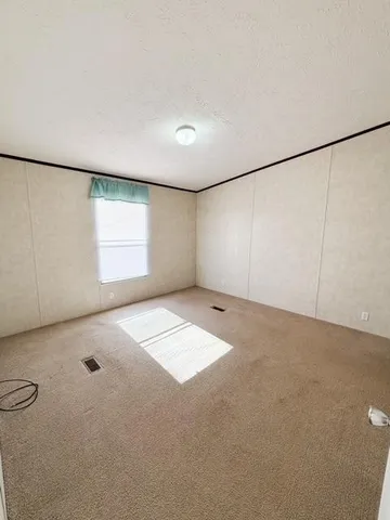 an empty room with a empty space and windows