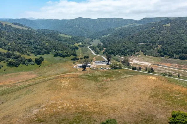a view of a town with mountains in the background