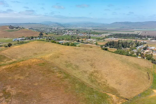 an aerial view of residential building and ocean view