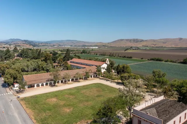 an aerial view of residential houses with outdoor space and river