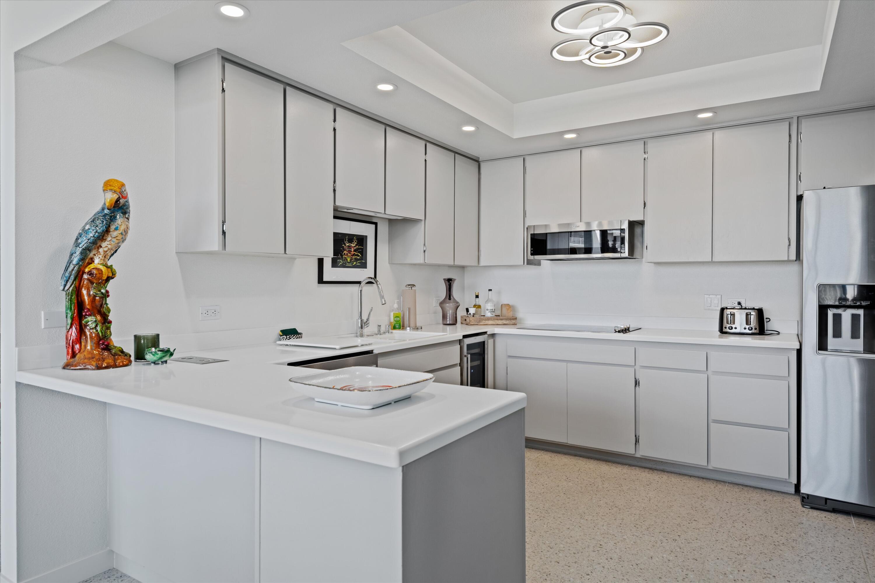 899 Island Drive, Unit 304 Rancho Mirage, CA 92270 - Photo 8 of 30 a kitchen with appliances cabinets and a sink