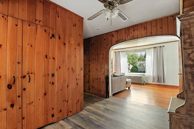 a view of a hallway with wooden floor and entryway
