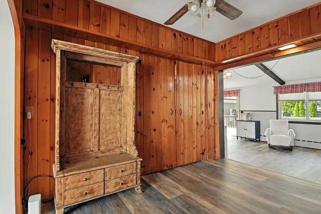 a view of a hallway with entryway wooden floor and windows