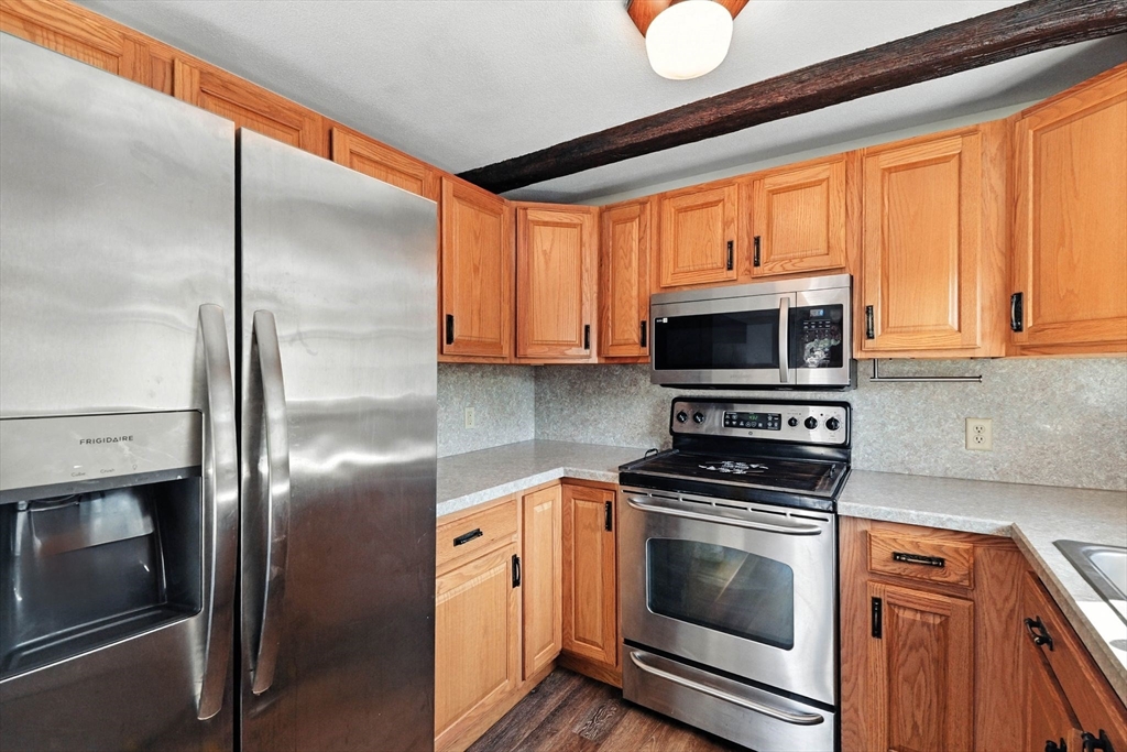 138 Suffield Street Agawam, MA 01001 - Photo 18 of 42 a kitchen with stainless steel appliances granite countertop a stove a refrigerator and a microwave