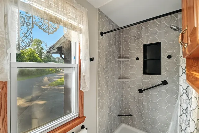 a bathroom with a glass shower door and a sink
