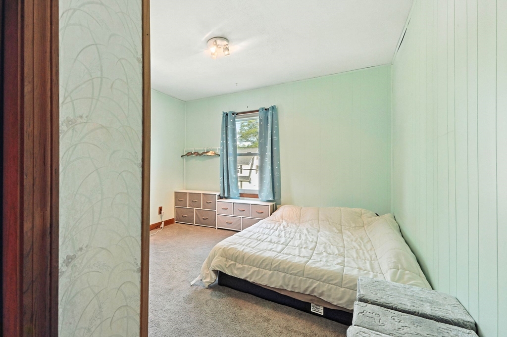 138 Suffield Street Agawam, MA 01001 - Photo 28 of 42 a spacious bedroom with a bed and glass door