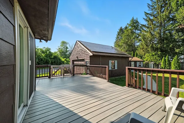 a view of backyard with deck and wooden floor