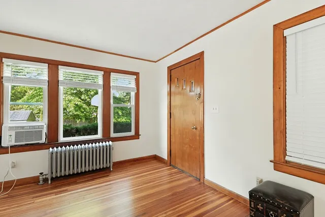 a view of a room with wooden floor and a window