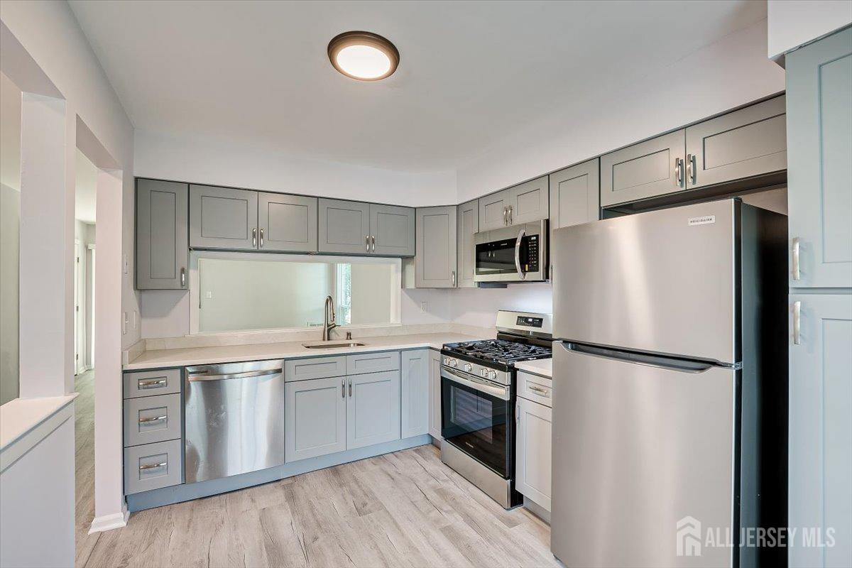 706 Maplecrest Road Edison, NJ 08820 - Photo 13 of 34 a kitchen with stainless steel appliances a refrigerator stove and microwave