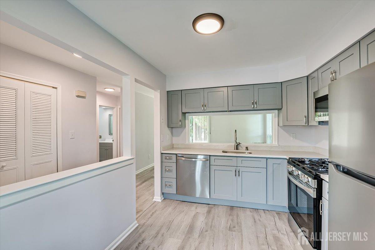 706 Maplecrest Road Edison, NJ 08820 - Photo 14 of 34 a kitchen with stainless steel appliances granite countertop a sink stove and refrigerator