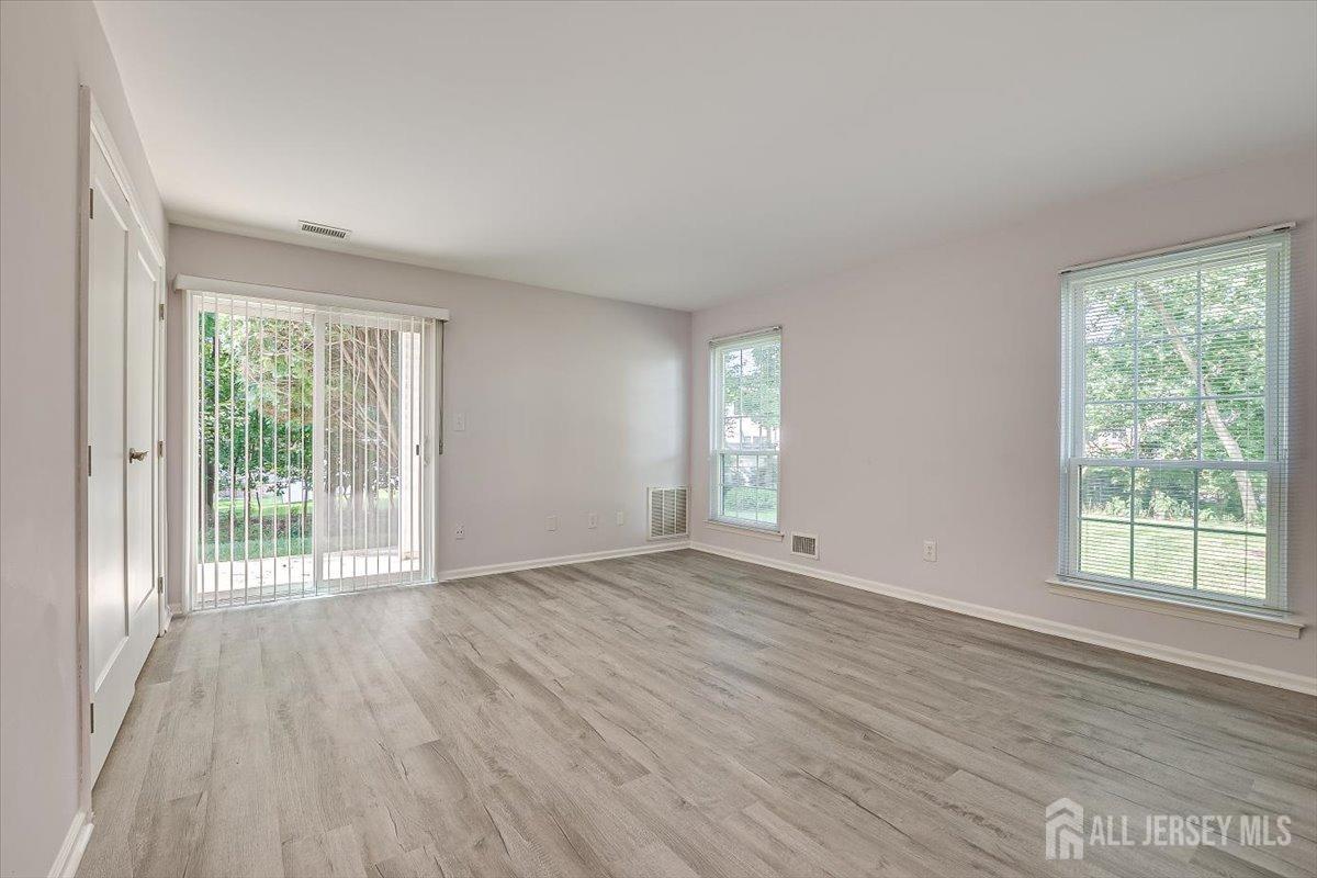 706 Maplecrest Road Edison, NJ 08820 - Photo 16 of 34 a view of an empty room with wooden floor and a window