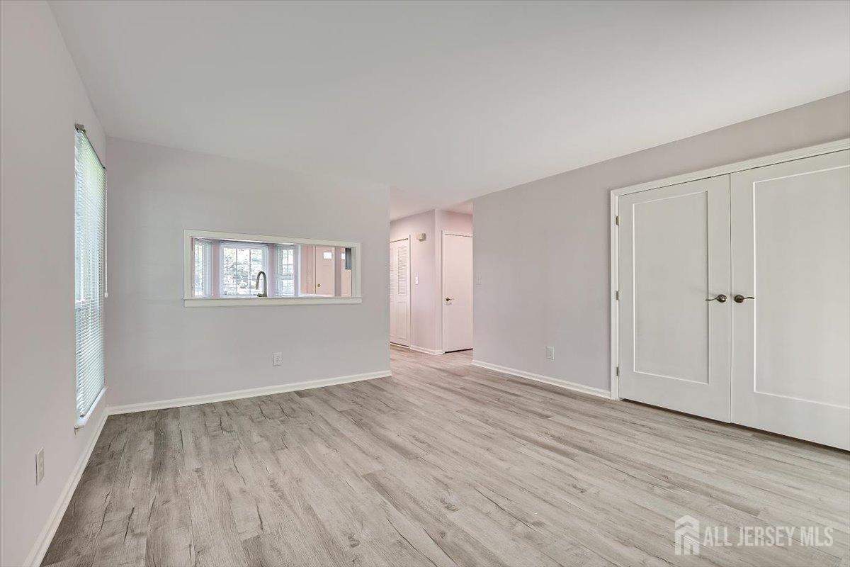706 Maplecrest Road Edison, NJ 08820 - Photo 17 of 34 an empty room with wooden floor and windows