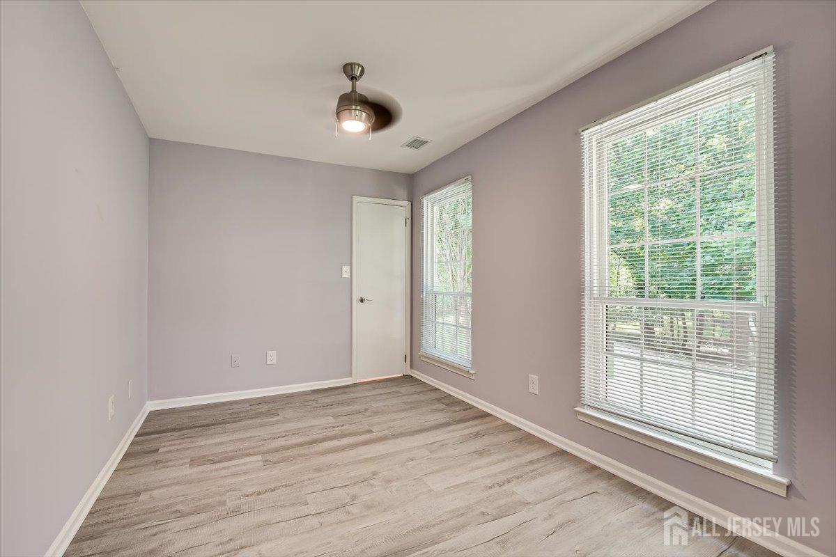 706 Maplecrest Road Edison, NJ 08820 - Photo 26 of 34 a view of an empty room with a window and wooden floor