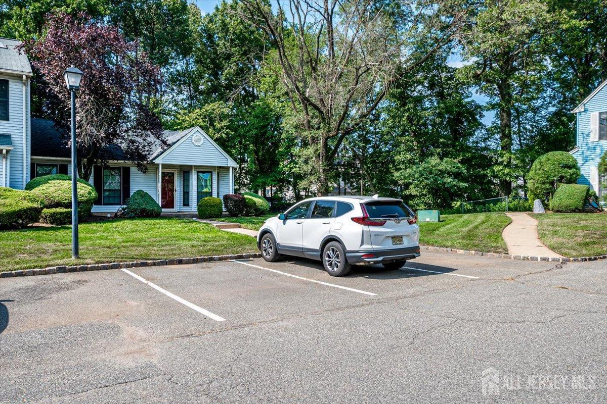 706 Maplecrest Road Edison, NJ 08820 - Photo 4 of 34 a car parked in front of a house with wooden fence