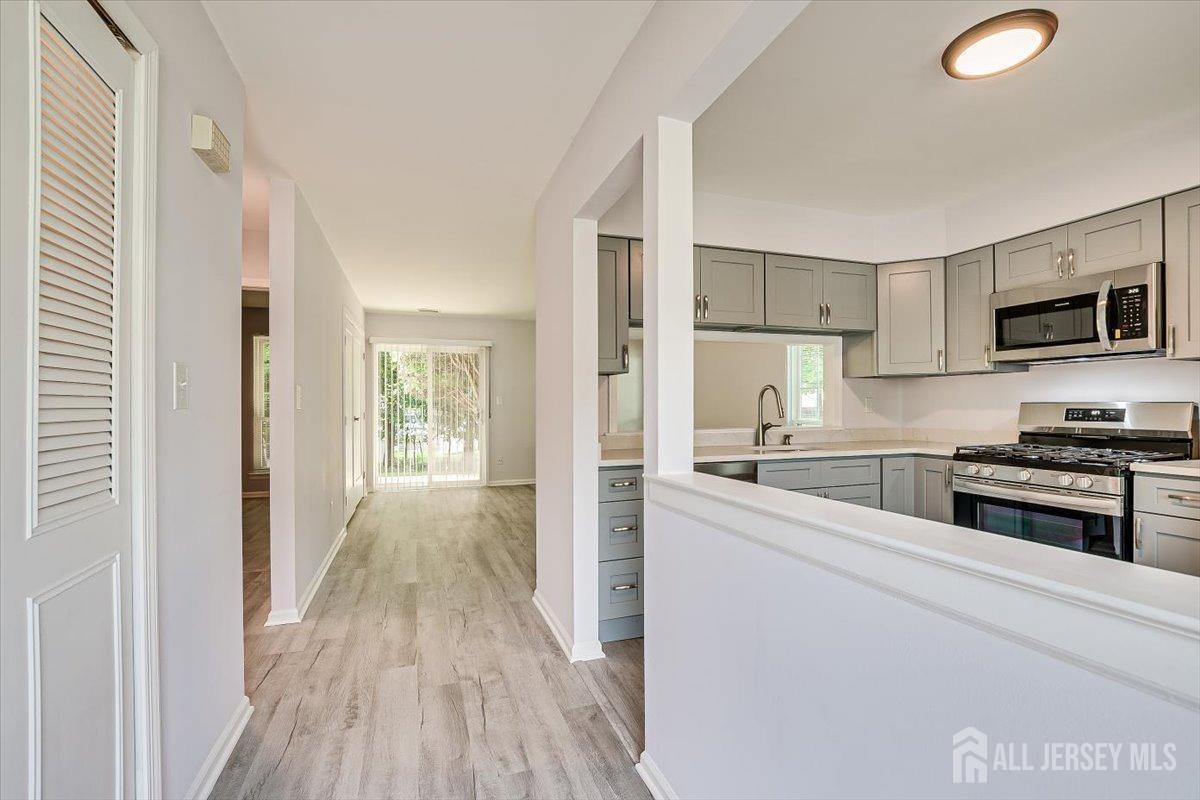 706 Maplecrest Road Edison, NJ 08820 - Photo 9 of 34 a kitchen with wooden floors and appliances