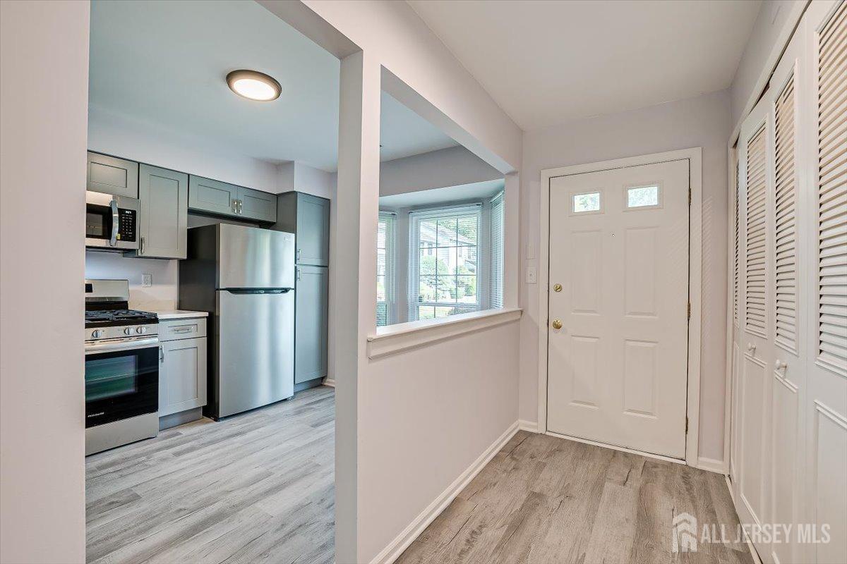 706 Maplecrest Road Edison, NJ 08820 - Photo 10 of 34 a view of kitchen with stainless steel appliances wooden floor and a window