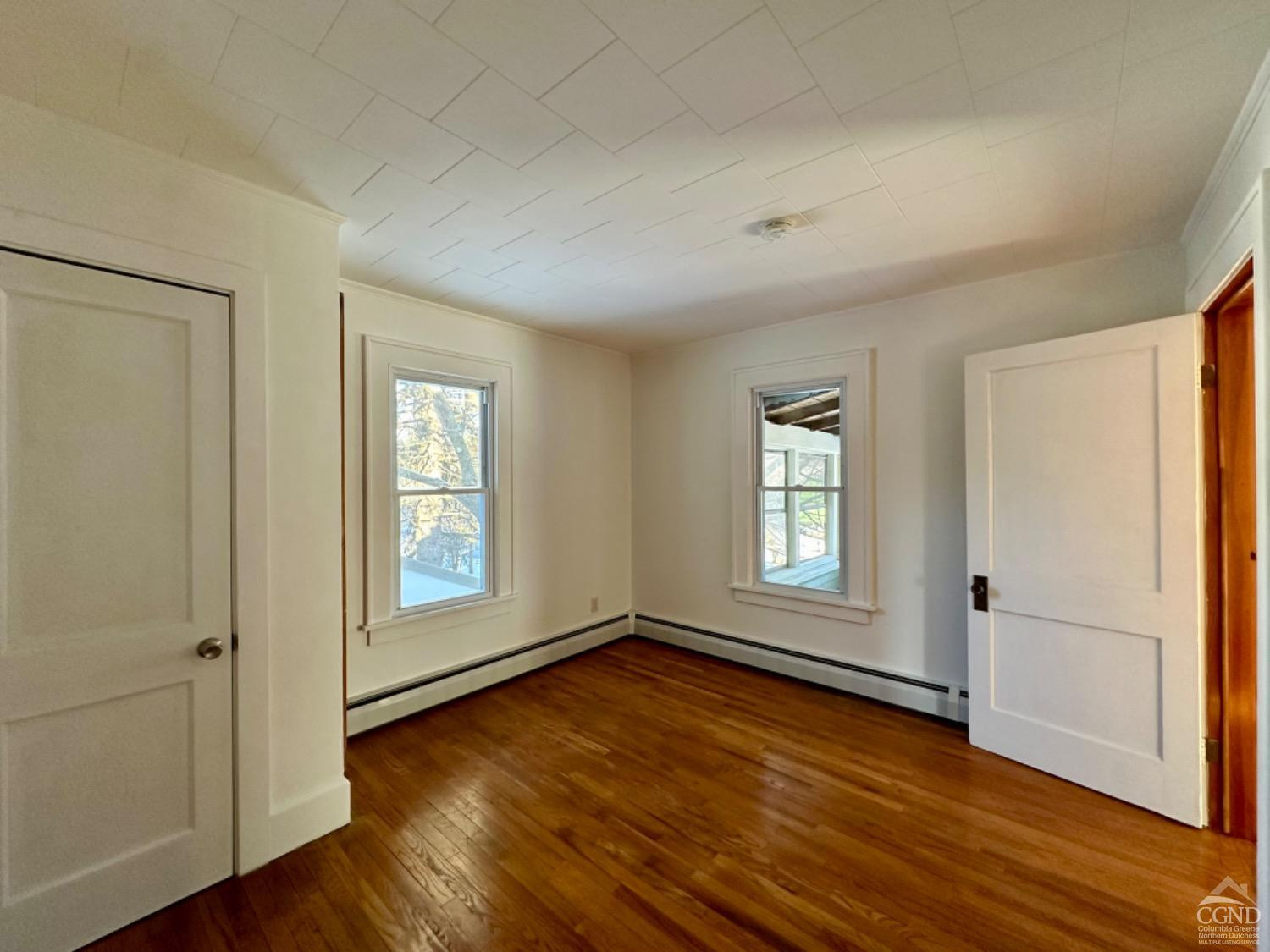 20 Eagle Street, Unit 2 Claverack, NY 12529 - Photo 13 of 20 an empty room with wooden floor and windows