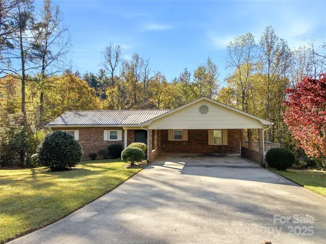 a front view of a house with a yard and trees