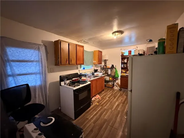 a kitchen with stainless steel appliances granite countertop a stove refrigerator and cabinets