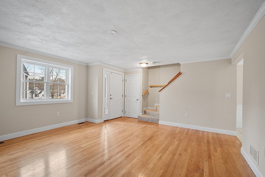 34 Lowell Road, Unit 4 Pepperell, MA 01463 - Photo 11 of 21 a view of an empty room with wooden floor and a window