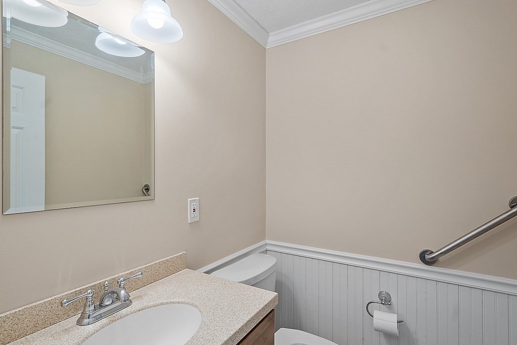 34 Lowell Road, Unit 4 Pepperell, MA 01463 - Photo 16 of 21 a bathroom with a sink and a mirror