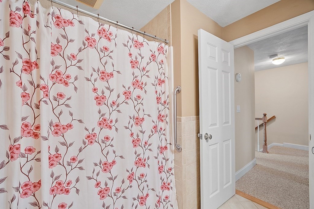 34 Lowell Road, Unit 4 Pepperell, MA 01463 - Photo 18 of 21 a view of bathroom with shower curtain