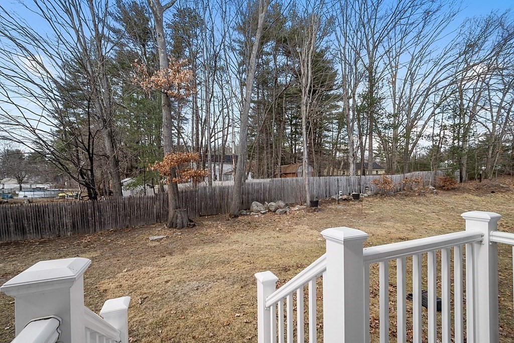34 Lowell Road, Unit 4 Pepperell, MA 01463 - Photo 3 of 21 a backyard of a house with table and chairs