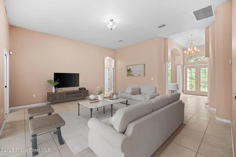 a living room with furniture and a flat screen tv