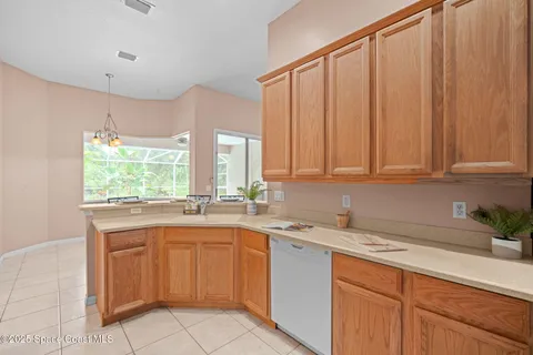 a kitchen with a sink window and cabinets