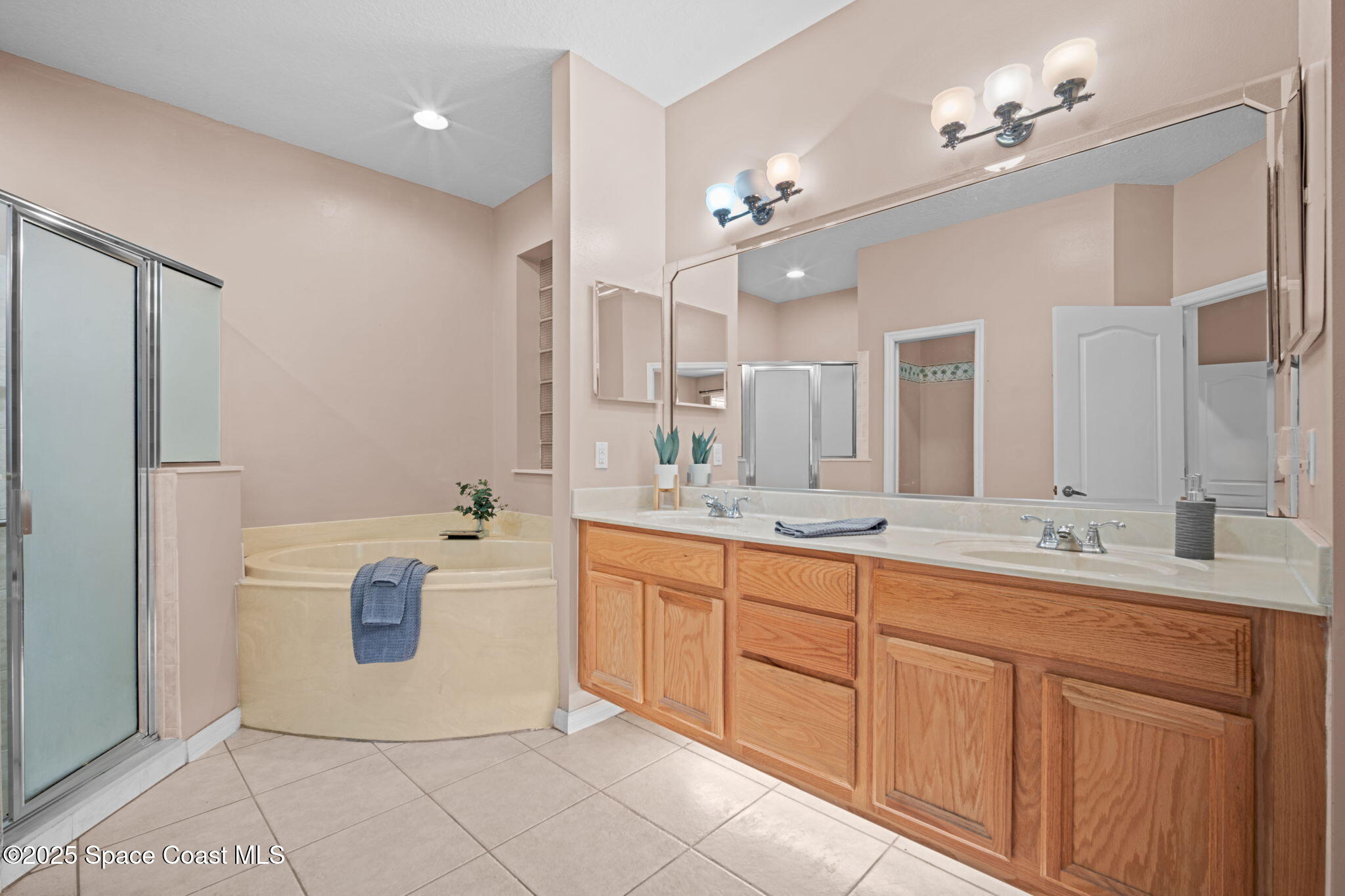 7635 Windover Way Titusville, FL 32780 - Photo 22 of 36 a spacious bathroom with a granite countertop sink a mirror and a bathtub