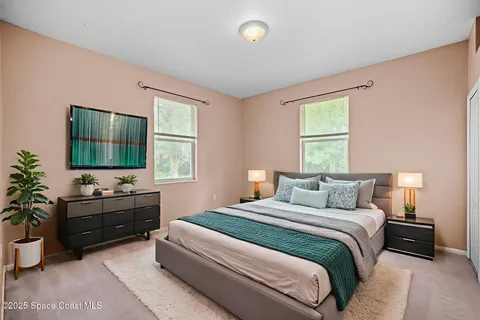 a bedroom with a bed and a flat screen tv