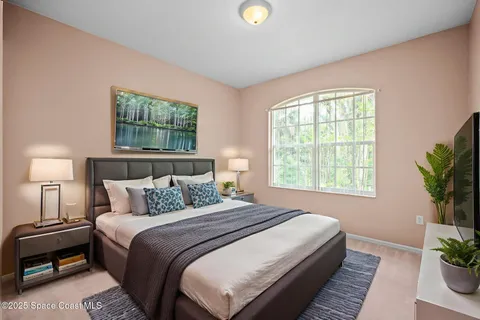 a bedroom with bed and a window