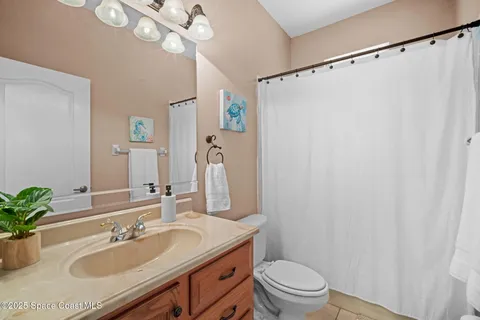a bathroom with a sink vanity mirror and toilet