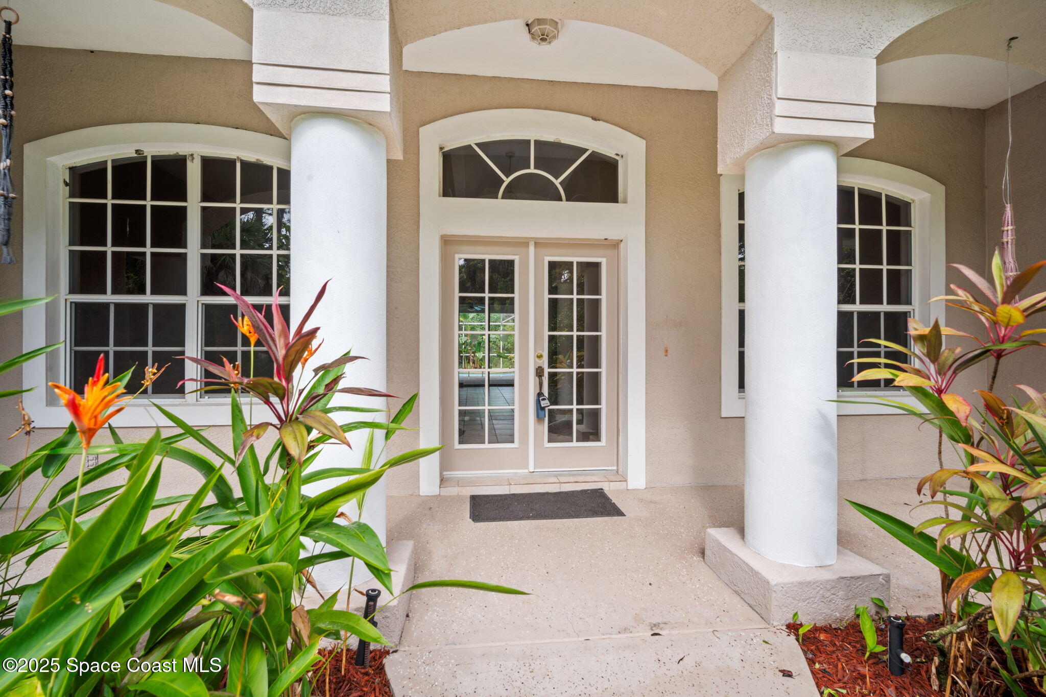 7635 Windover Way Titusville, FL 32780 - Photo 4 of 36 a front view of a house with a yard