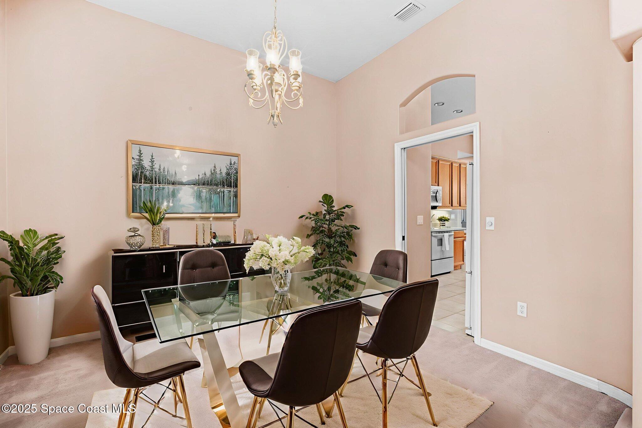 7635 Windover Way Titusville, FL 32780 - Photo 7 of 36 a living room with furniture and a chandelier