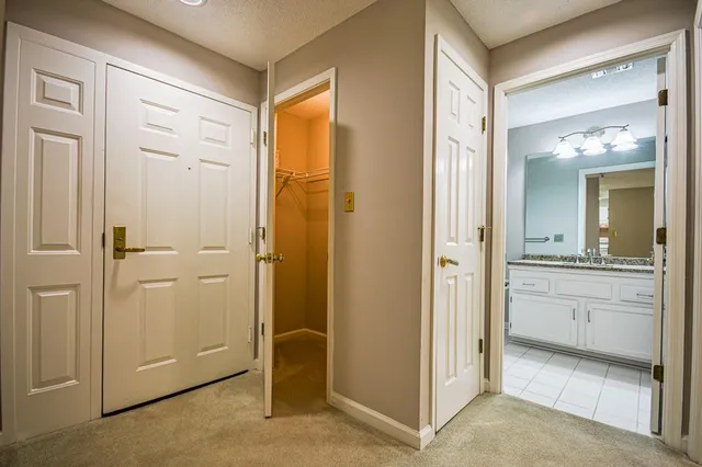 a bathroom with a granite countertop sink mirror and shower