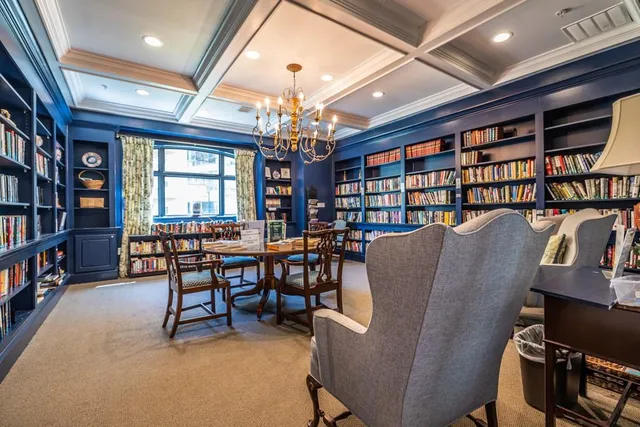 a view of a livingroom with furniture and a bookshelf