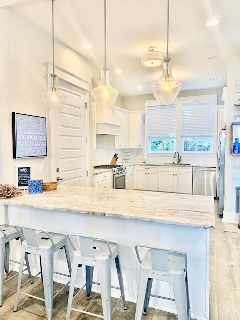 166 Cabana Trail Santa Rosa Beach, FL 32459 - Photo 4 of 23 a kitchen with stainless steel appliances kitchen island granite countertop a table chairs in it and wooden floors