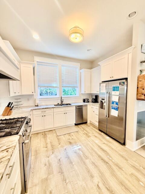 166 Cabana Trail Santa Rosa Beach, FL 32459 - Photo 6 of 23 a large kitchen with kitchen island a stove a sink dishwasher and white cabinets with wooden floor
