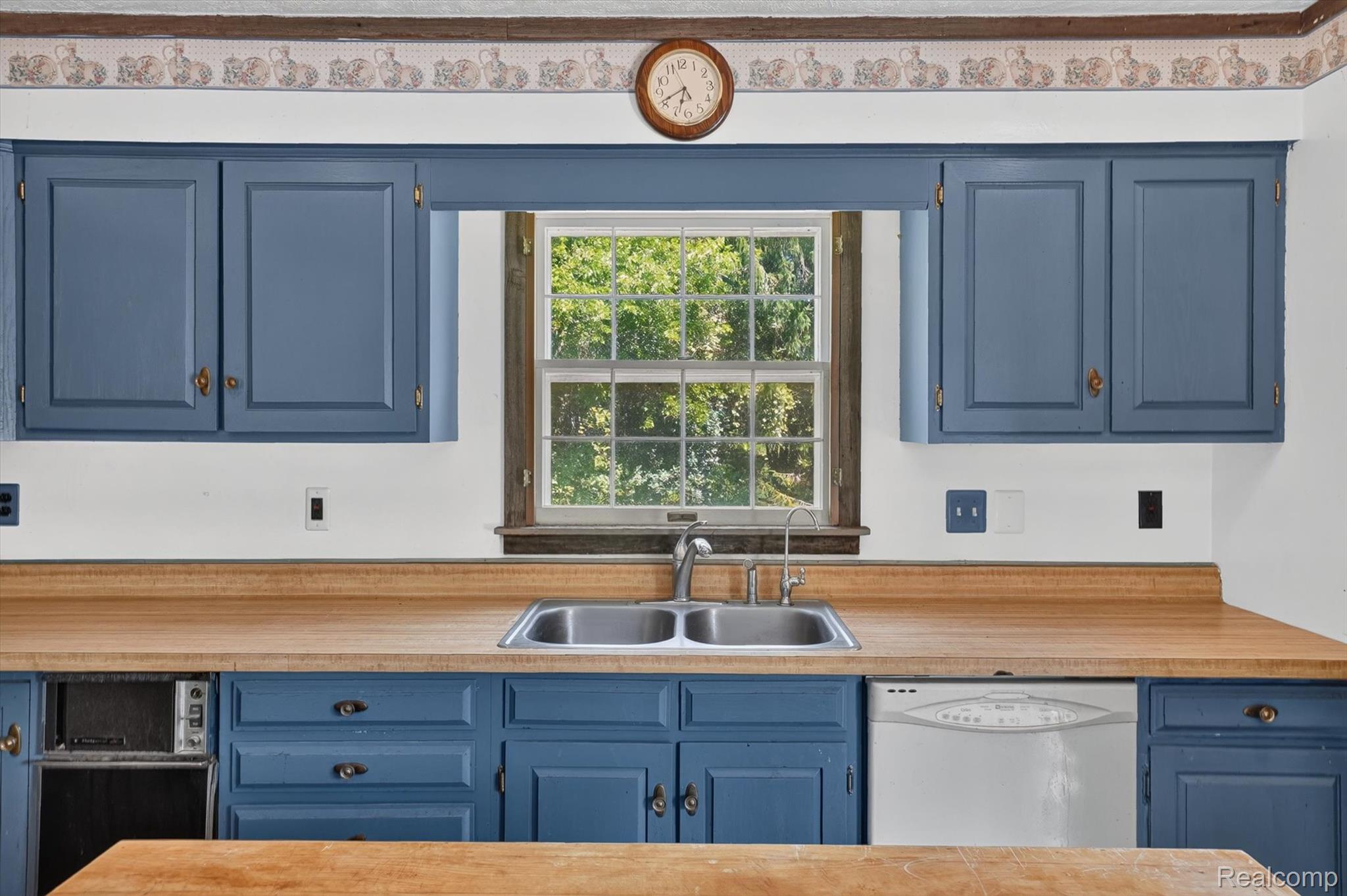 3760 Webberville Road North Williamston, MI 48895 - Photo 14 of 80 Kitchen featuring blue cabinetry, a stainless steel double basin sink, and wood-finish countertops