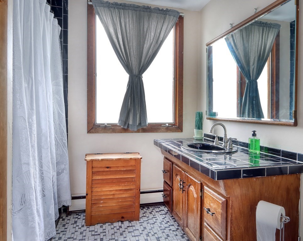 31-33 Rockingham Street Cambridge, MA 02139 - Photo 17 of 22 a kitchen with a stove a sink and a window